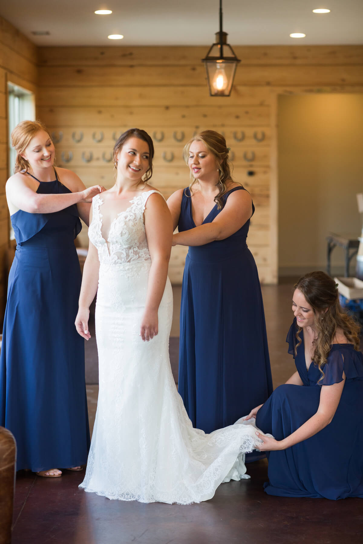 Bridesmaids helping bride get dressed | Fall Wedding at King Family Vineyards by Virginia Photographers