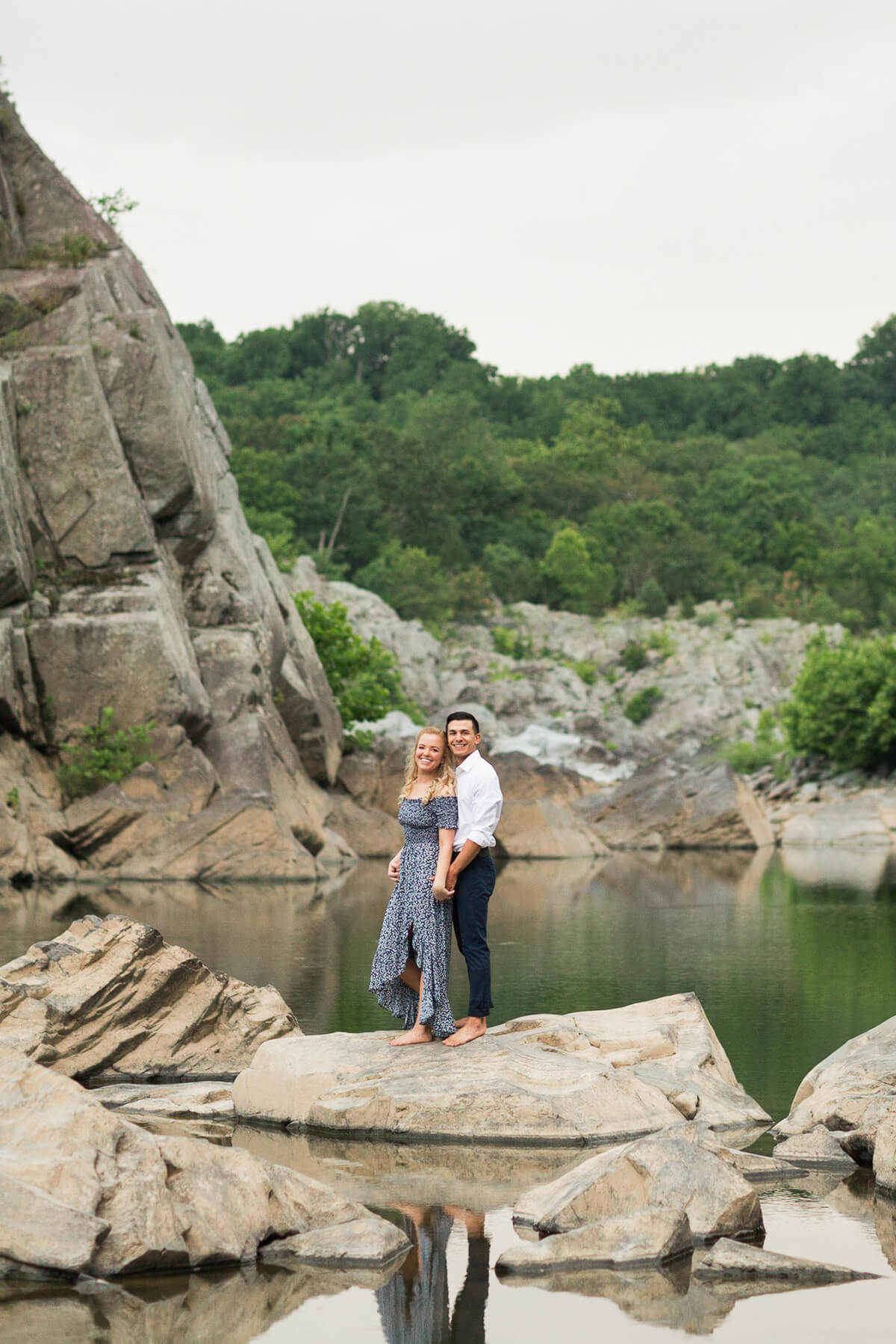 Couple posing on rocks at Great Falls during engagement session