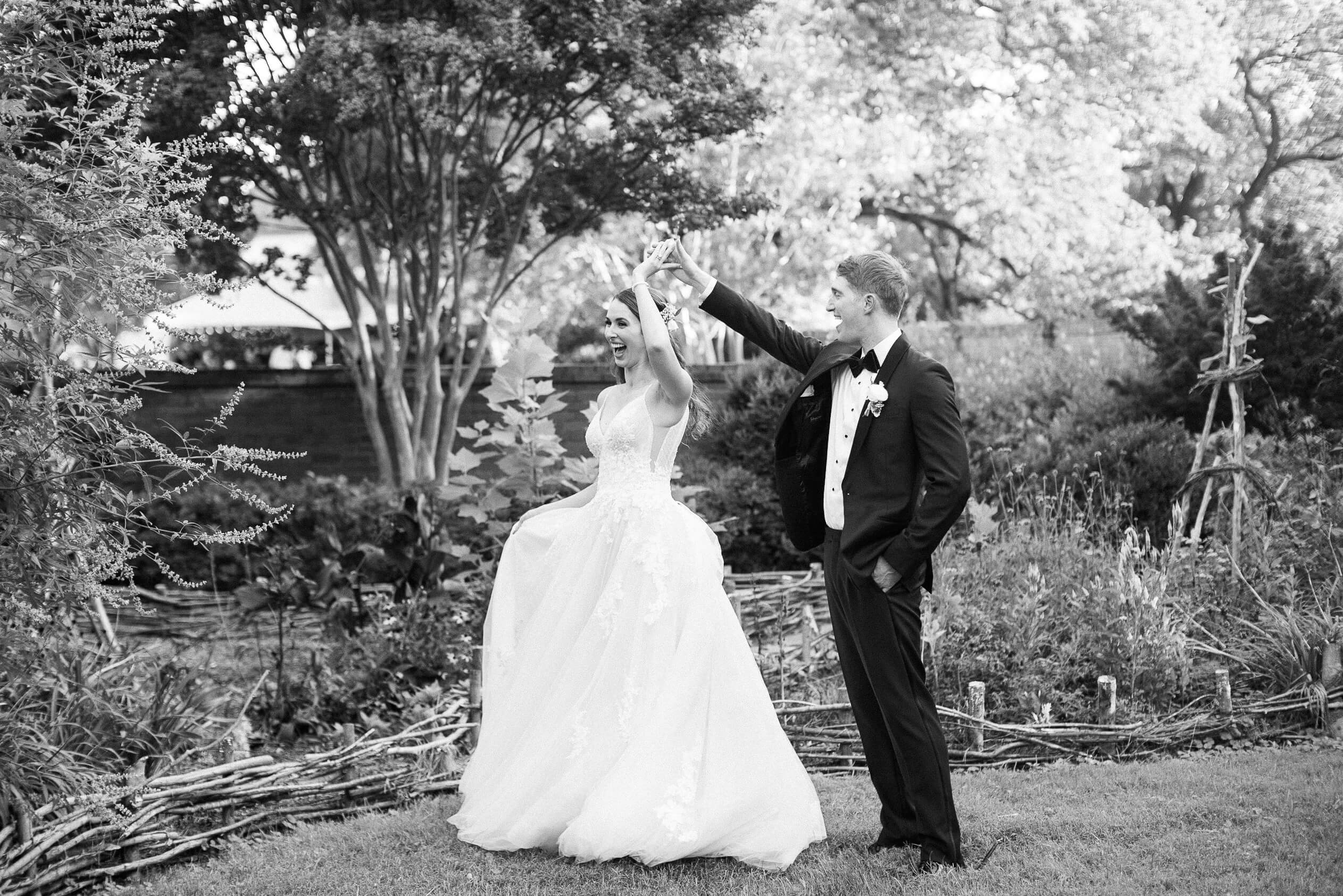 Groom spinning bride in wedding dress